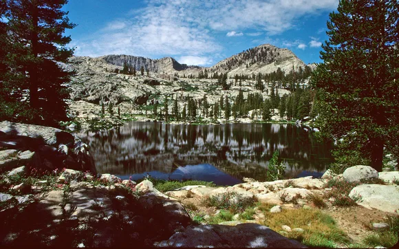A large lake surrounded by forest covered granite walls.