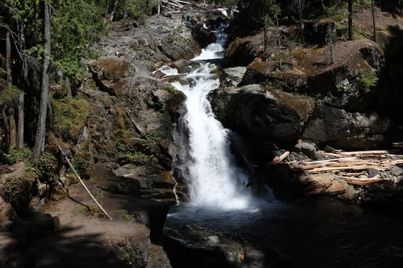 A cascading waterfall flows over steep rocks